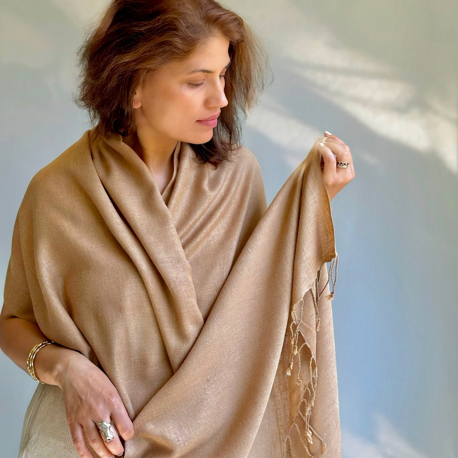 Woman wearing light brown scarf.