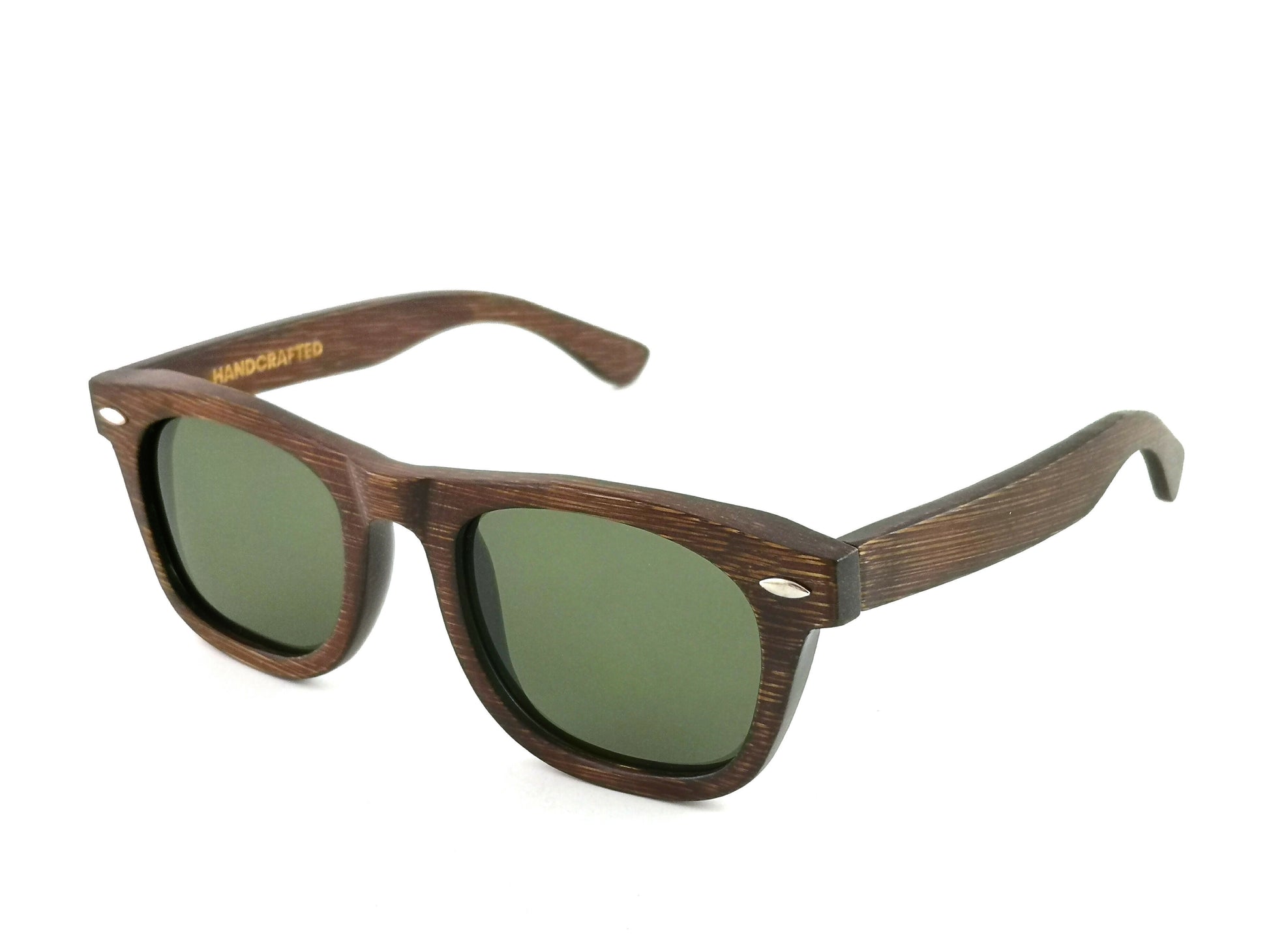 Diagonal view of bamboo wayfarer style sunglasses with brown frames and grey lenses.