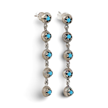Pair of gold dangle earrings with five discs each and turquoise glass in each disc.