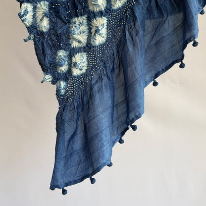 Close-up of dark blue indigo-dyed mulberry silk sari showing white diamond shibori fold-resist pattern on the pallu.