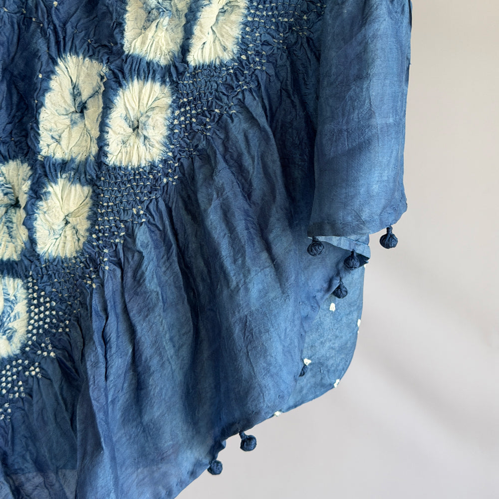 Close-up of dark blue indigo-dyed mulberry silk sari showing white diamond shibori fold-resist pattern on the pallu.