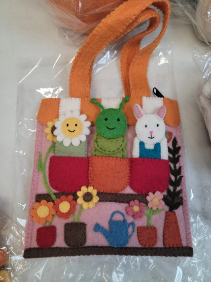Felt flower shop puppet bag with removable flower, caterpillar and bunny felt finger puppets.