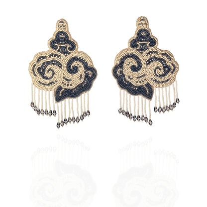Pair of white and black cloud earrings with tassels.