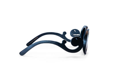 Side view of black bamboo sunglasses with black frames with scroll like design on arms.