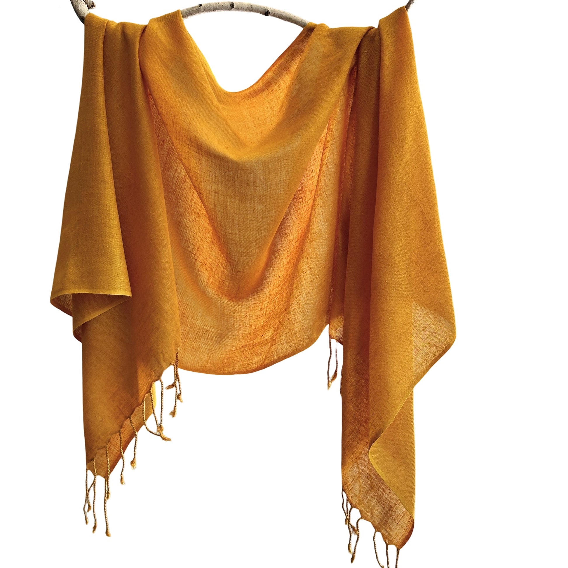 Gold silk scarf draped on branch.